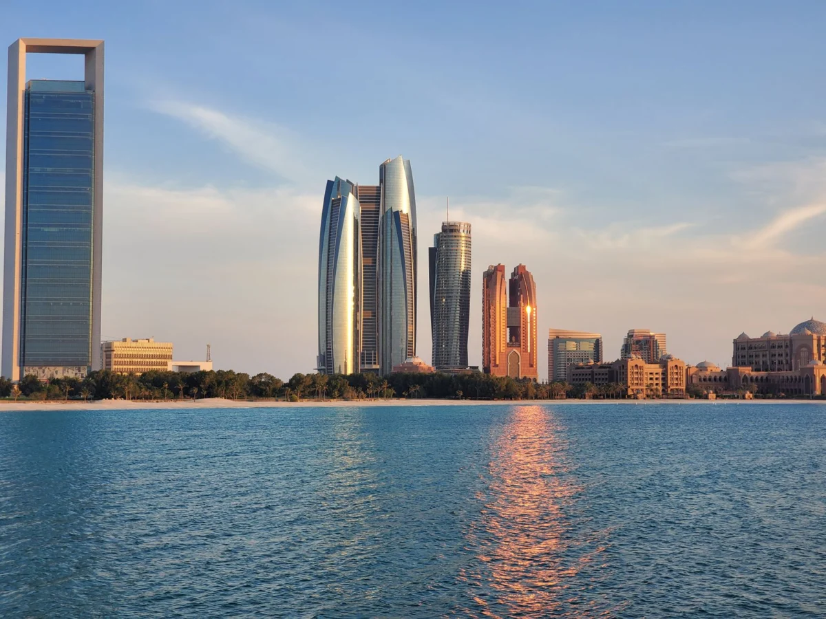 Abu Dhabi's skyline bathed in sunset hues, reflecting a tranquil ambience