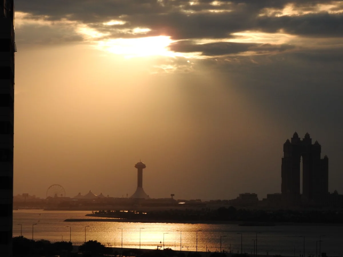 Romantic Abu Dhabi skyline at sunset featuring iconic landmarks
