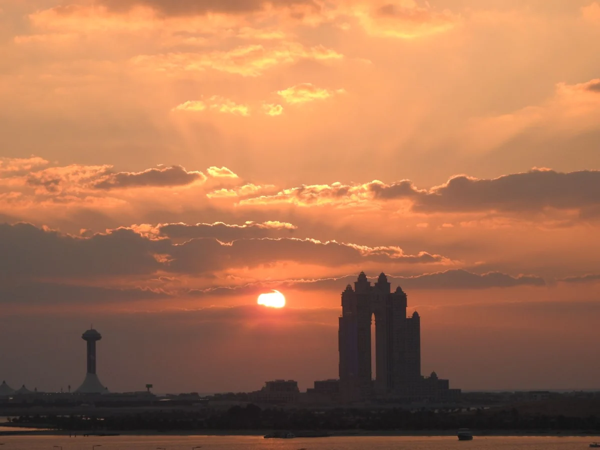 Scenic view of Abu Dhabi skyline at sunset, ideal for adventure backpackers