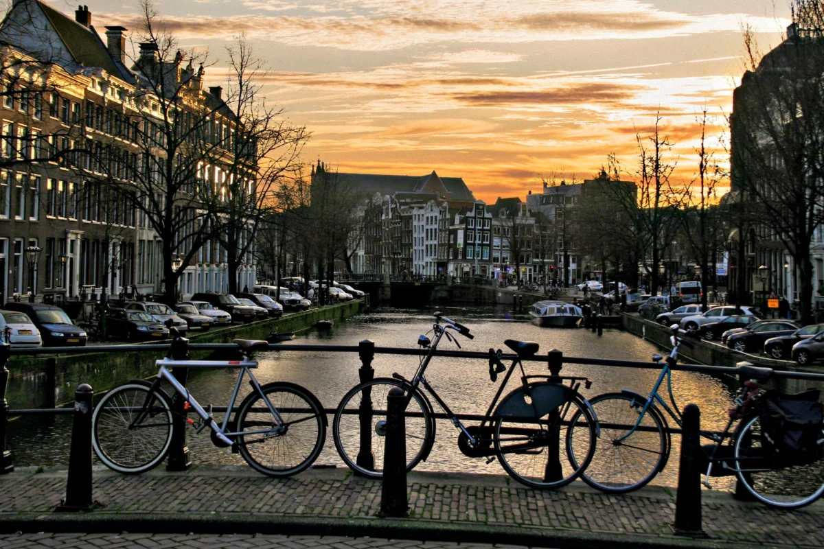 Romantic sunset over an Amsterdam canal lined with historic buildings