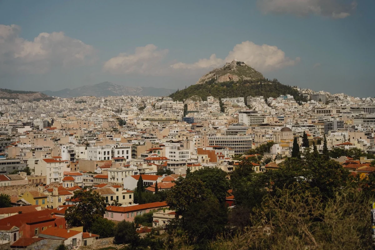 Rooftop view of Athens cityscape at sunset