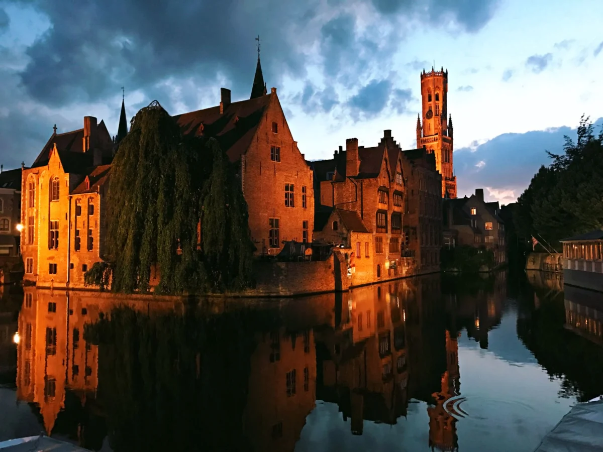 Romantic view of Bruges canals at twilight with historic buildings