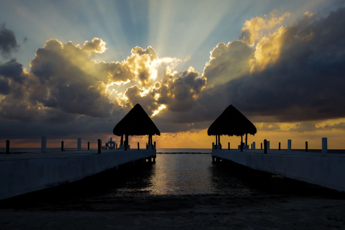 Romantic sunset over Cancun lagoon with historical backdrop
