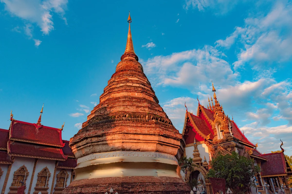 View of a historic temple in Chiang Mai with lush surroundings