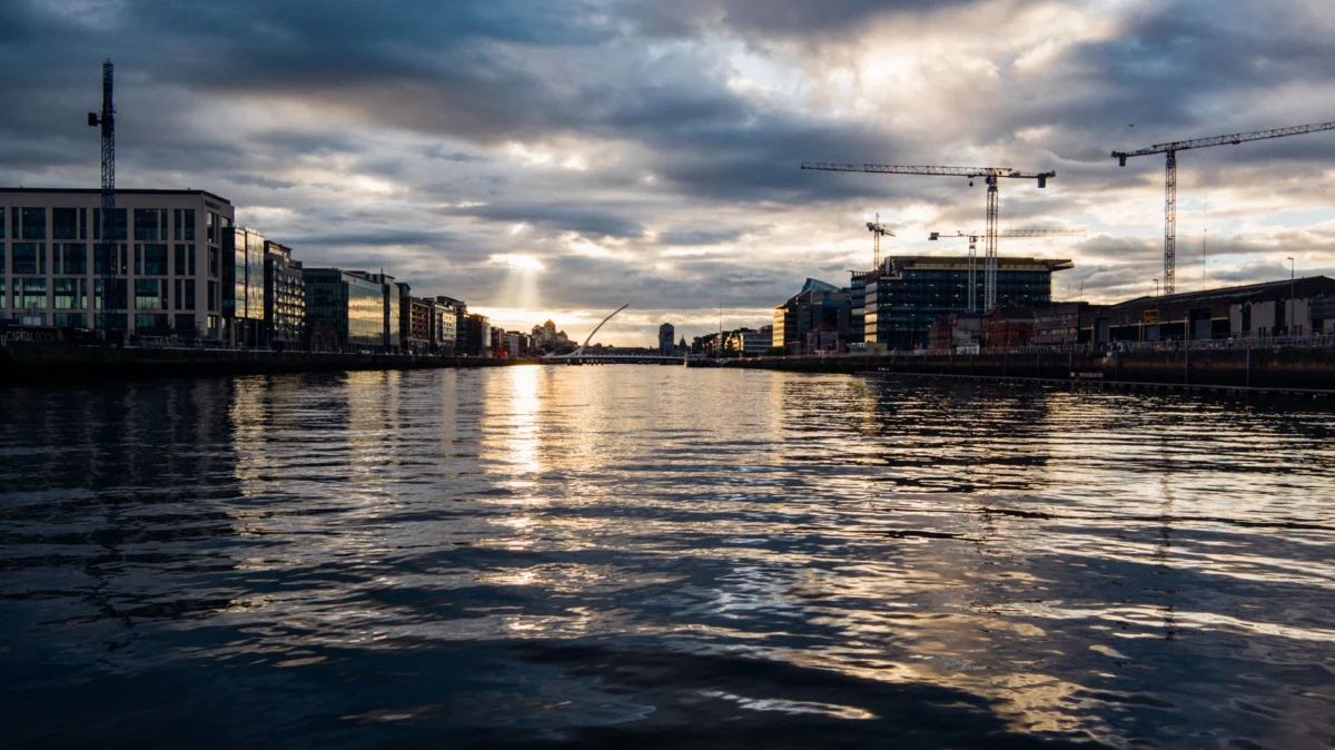 Romantic Dublin skyline featuring lush riverbanks at dusk