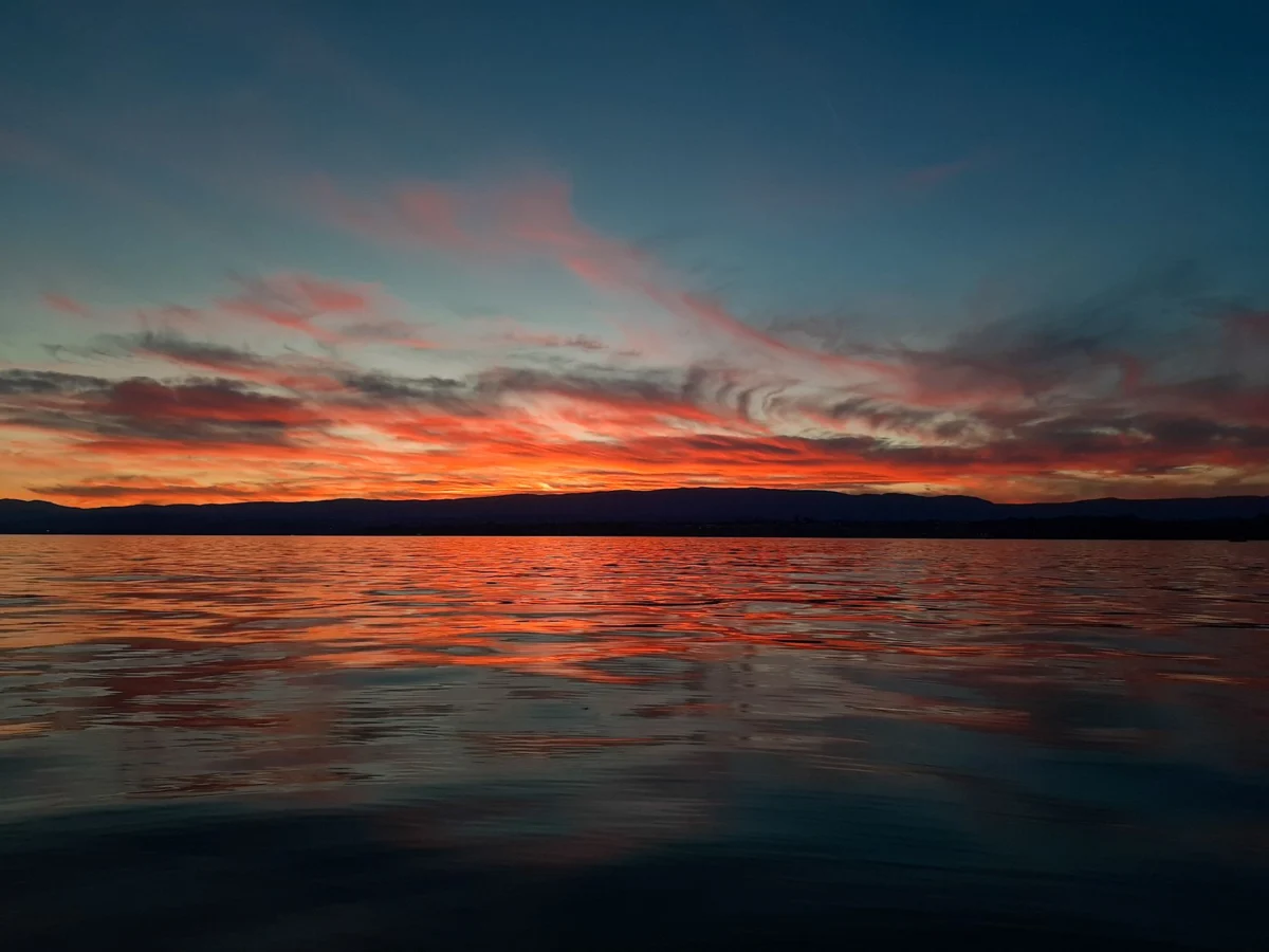 Sunset view over Geneva's iconic lake and cityscape