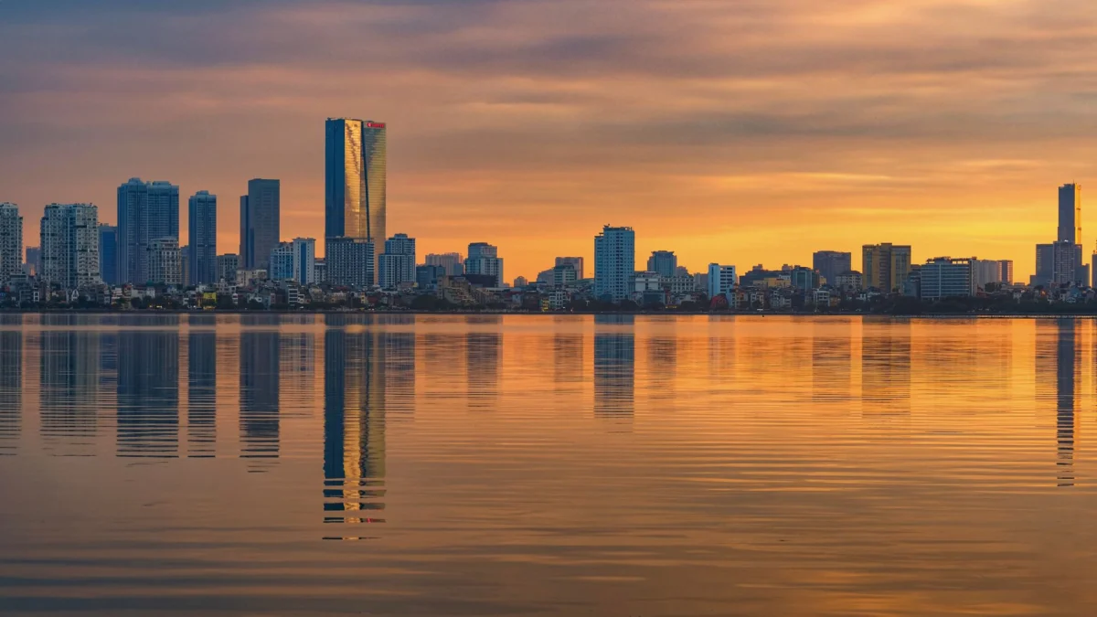 A romantic view of Hanoi's skyline at sunset with sparkling lights