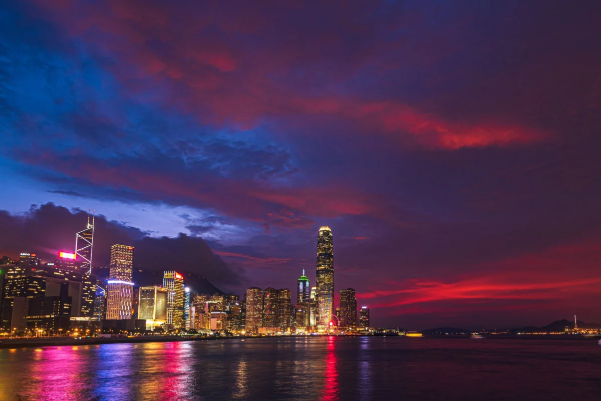 Nighttime view of the Hong Kong skyline with illuminated skyscrapers
