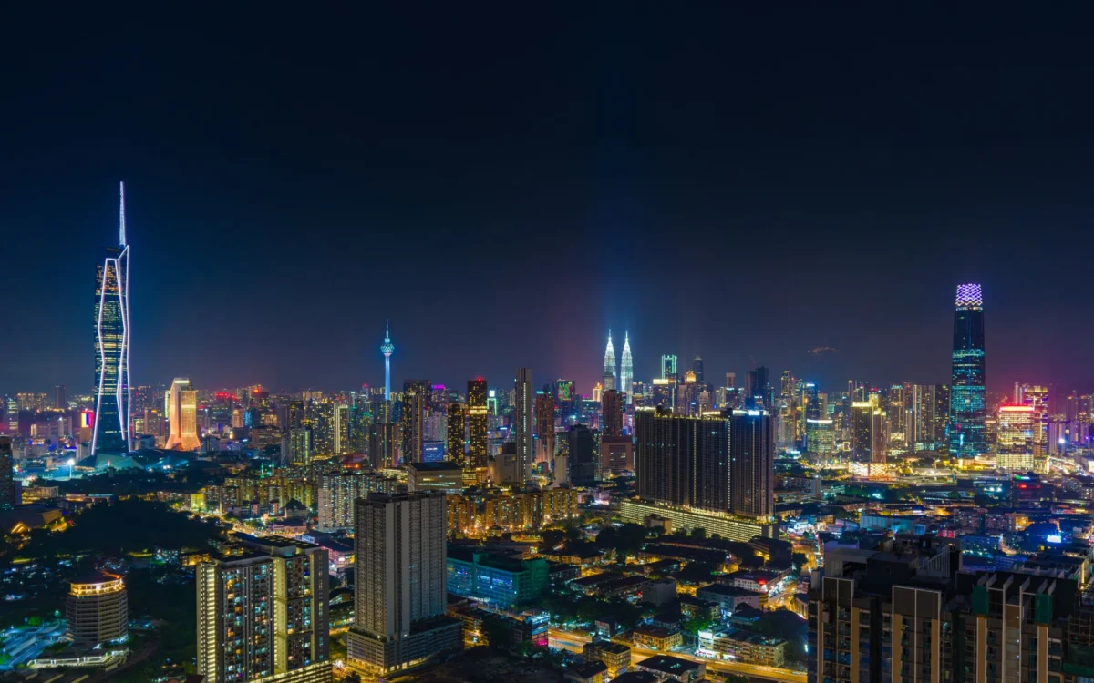 Skyline view of Kuala Lumpur at night with the iconic Petronas Towers