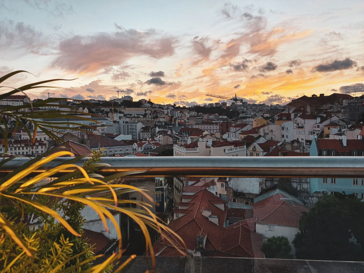 View of Lisbon city with sunset over rooftops