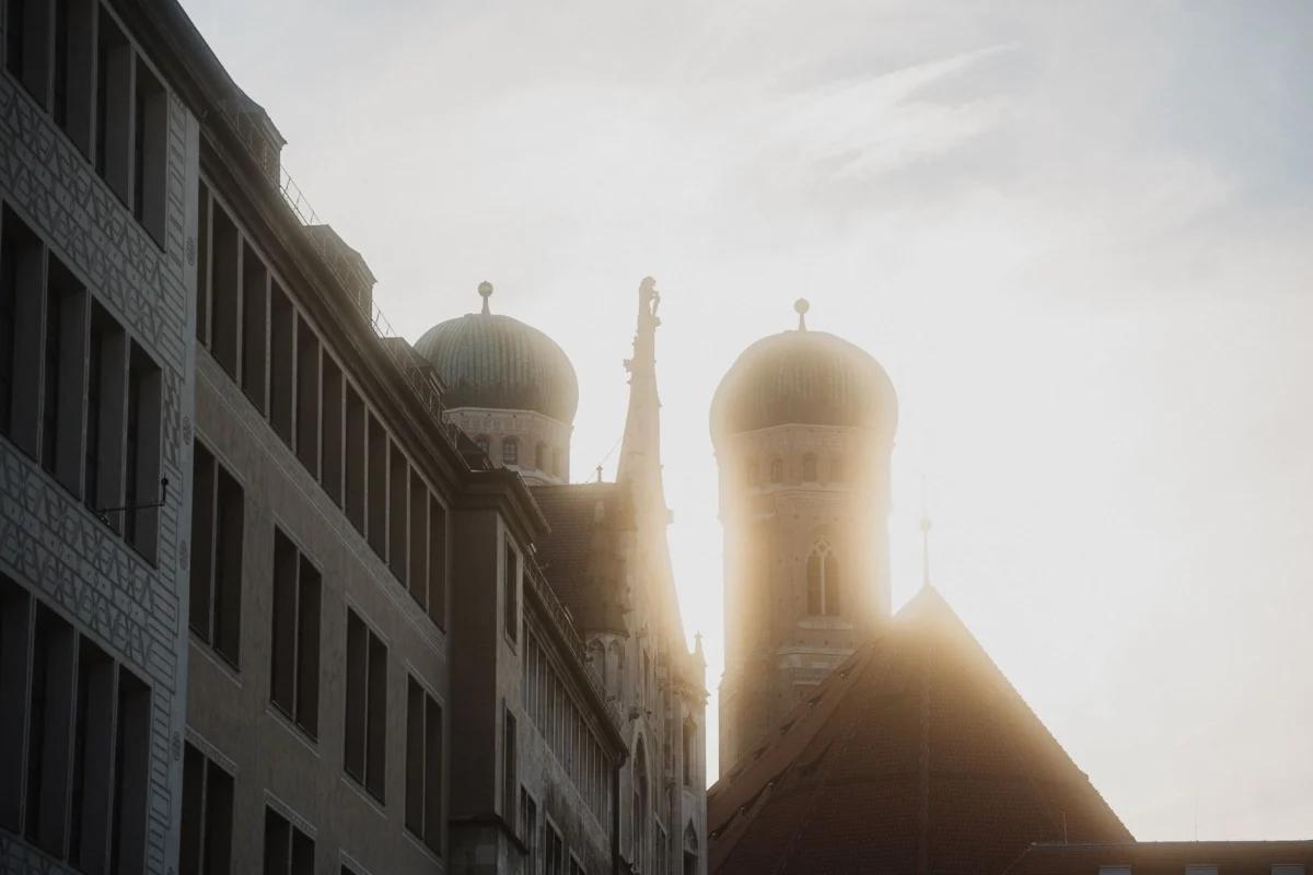 Munich skyline at sunset with iconic landmarks