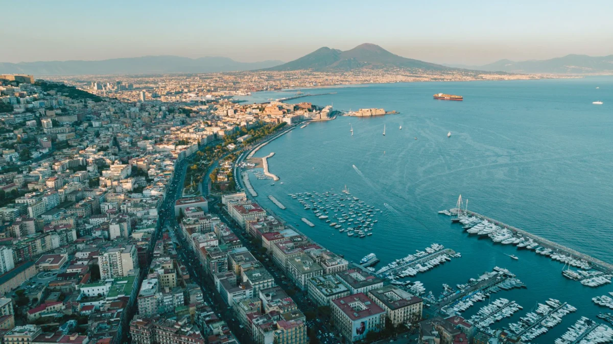 Naples skyline at sunset with iconic historical landmarks