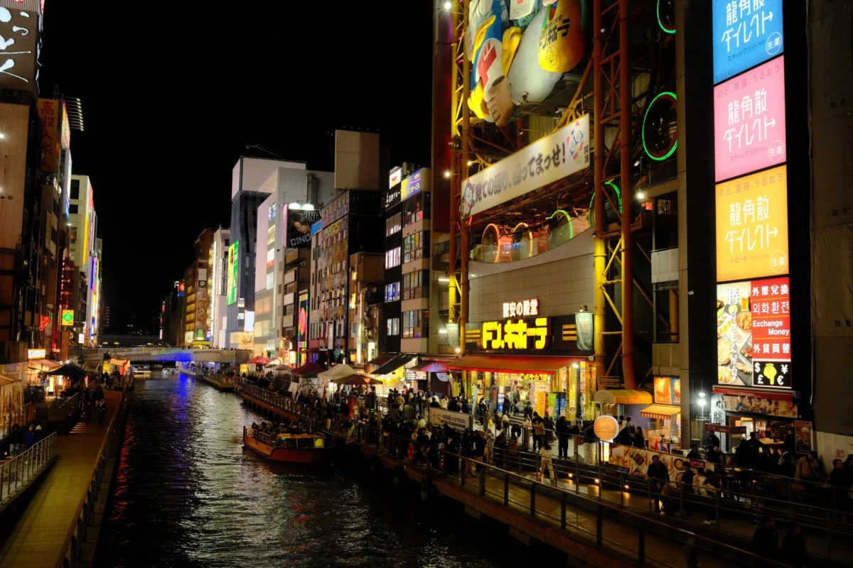 Night view of Dotonbori in Osaka, showcasing vibrant lights and reflections