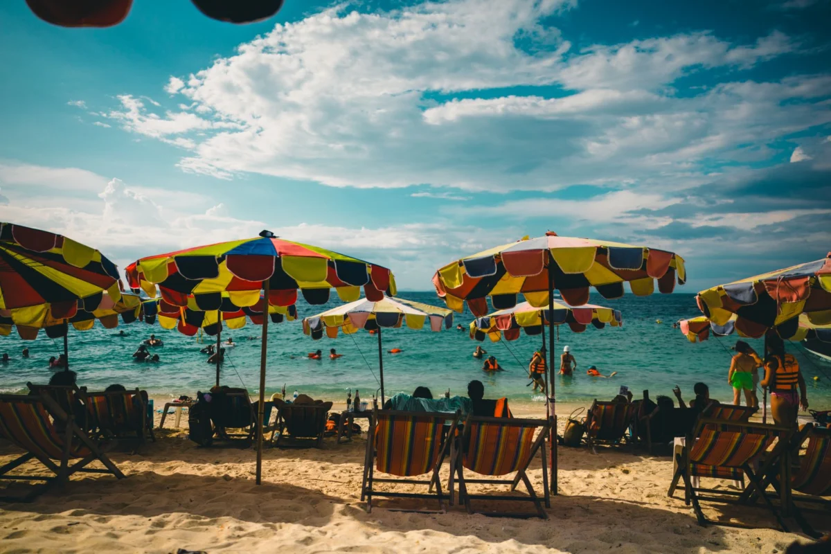 Vibrant beachfront in Phuket with clear blue waters and lively atmosphere