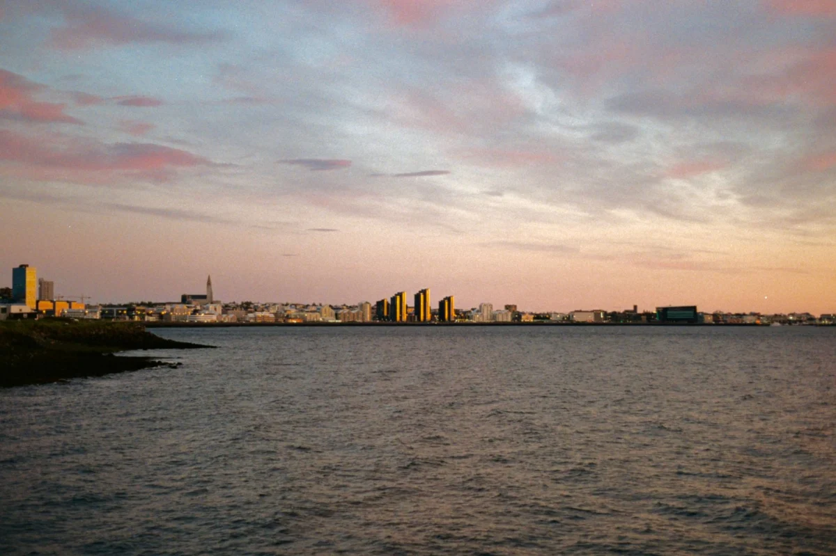 Reykjavik skyline at sunset with mountains in the background