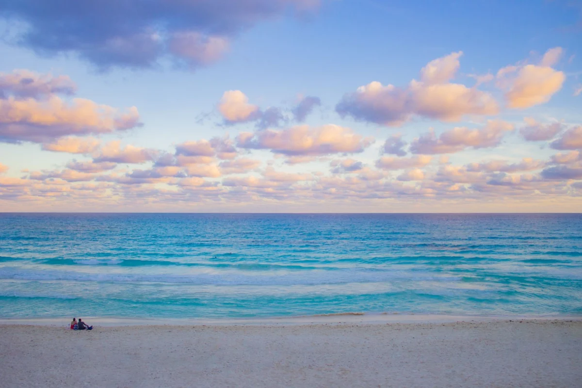 Couple enjoying a romantic sunset on Cancun beach
