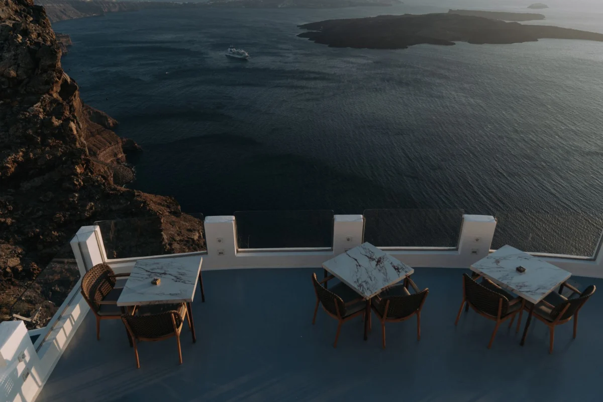 Couple dining at a sunset restaurant overlooking Santorini