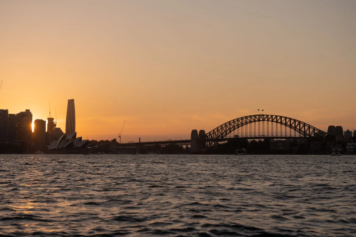 Sydney Harbour and city skyline at sunset with historical landmarks