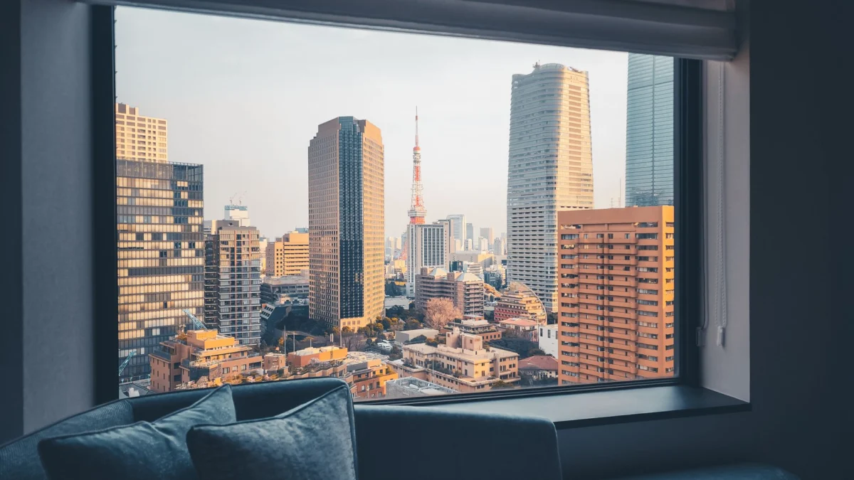 Family enjoying a sunny day in a Tokyo park with skyline views