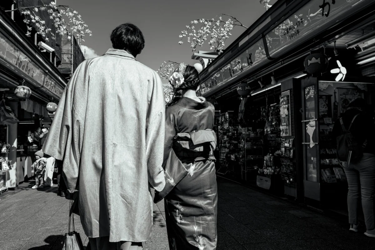 Couple walking down a traditional street in Tokyo, embracing history