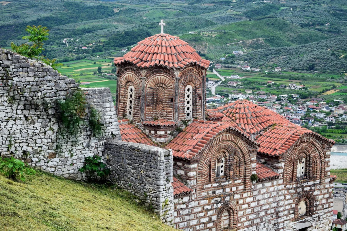 Sunset view of Berat's historic skyline with castle
