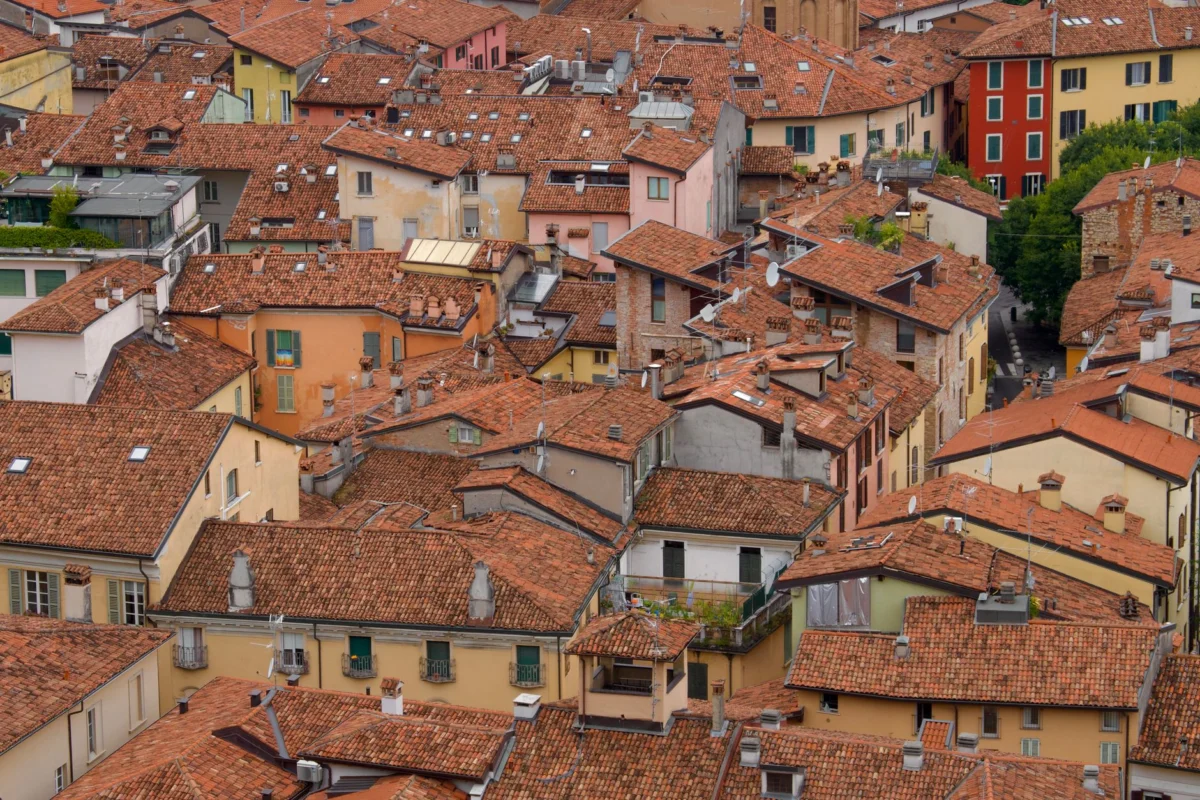 Aerial view of Bologna showcasing its iconic terracotta rooftops.
