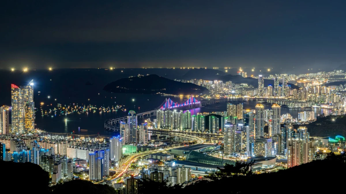 Moonlit view of Busan's skyline with sparkling city lights