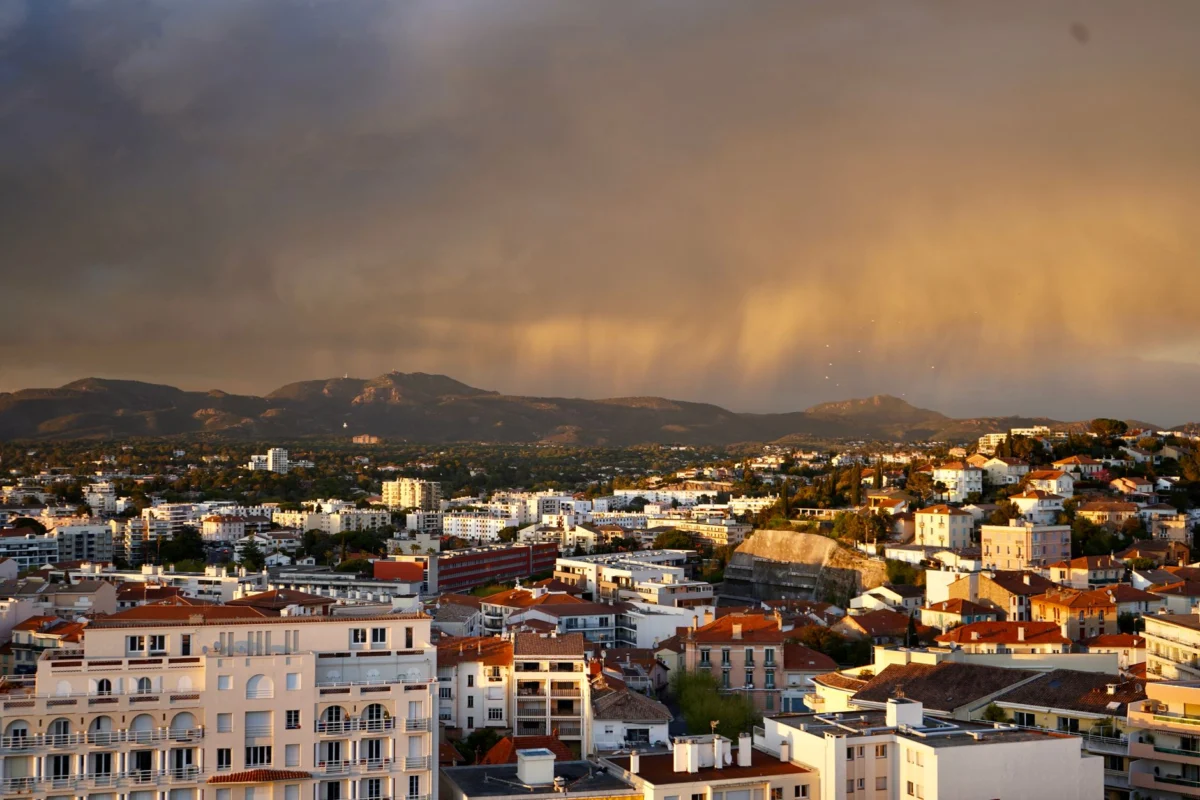 Sunset view of Cannes harbor with cityscape