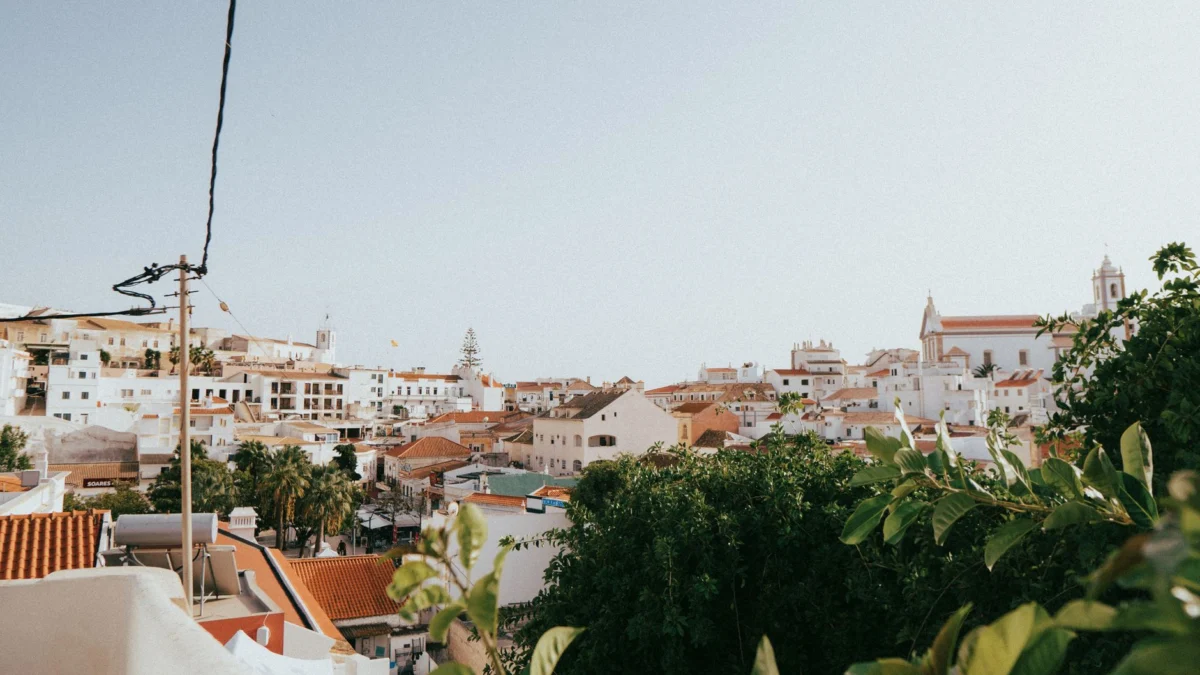 A scenic view of Faro’s old town skyline at sunset