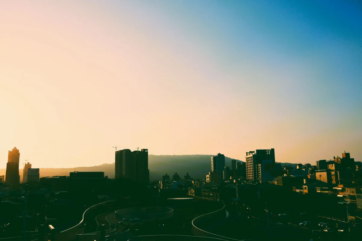 Dramatic sunset over Fukuoka skyline with city lights
