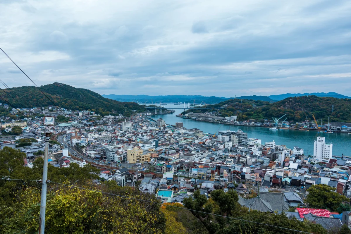 Hiroshima city's skyline at dusk with tranquil river view