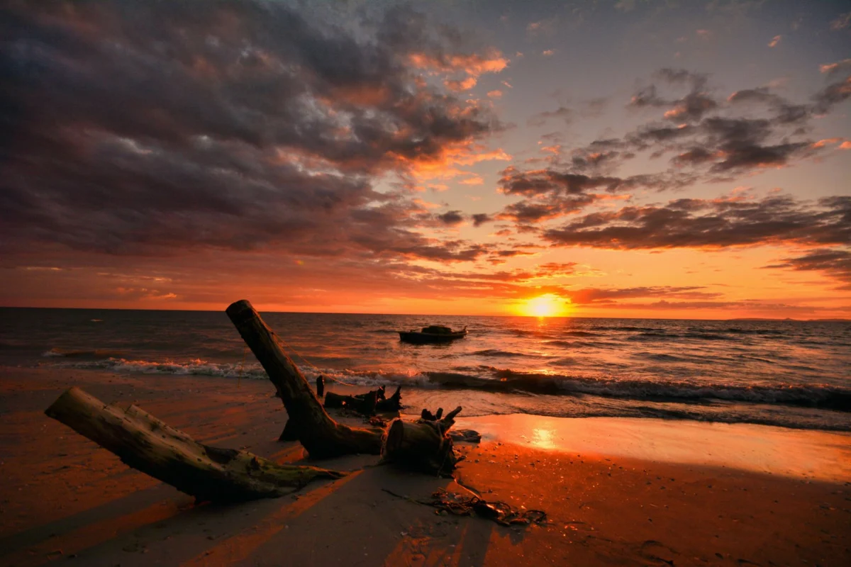 A serene sunrise over a pristine beach in Koh Phangan
