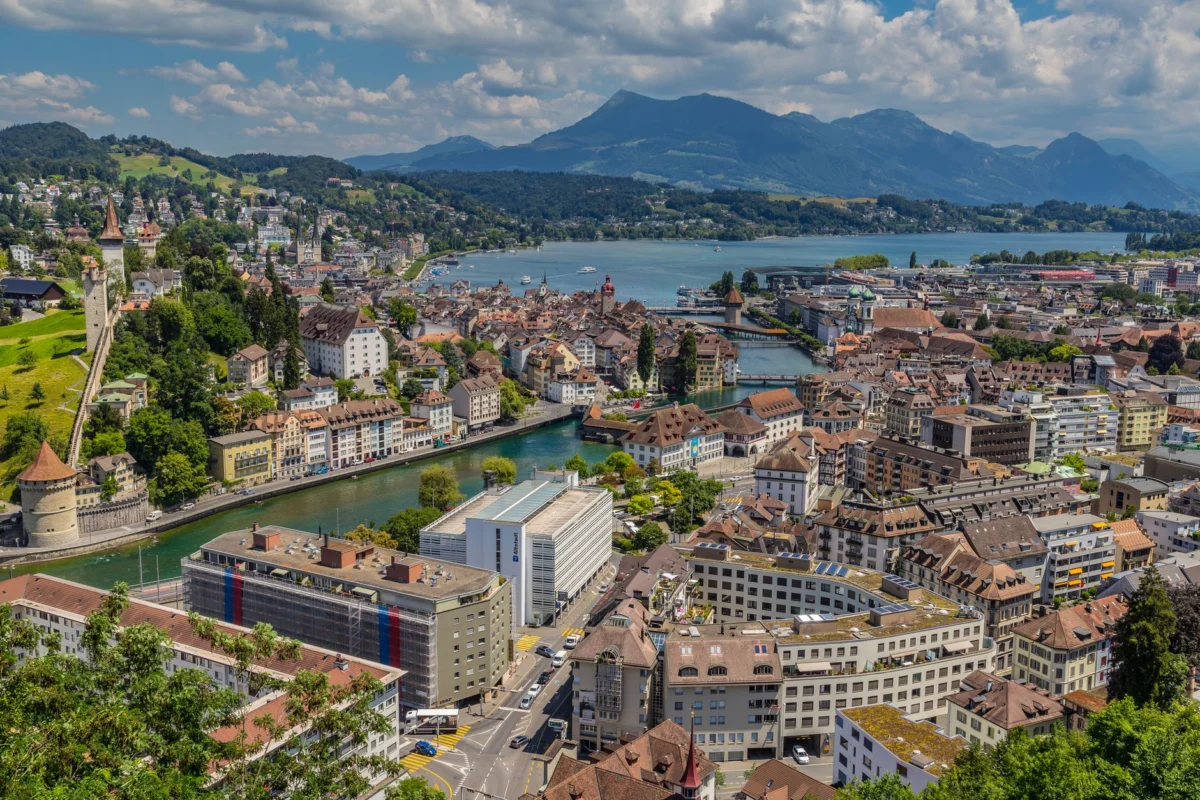 Scenic view of Lucerne's skyline with lake, ideal for culinary travelers