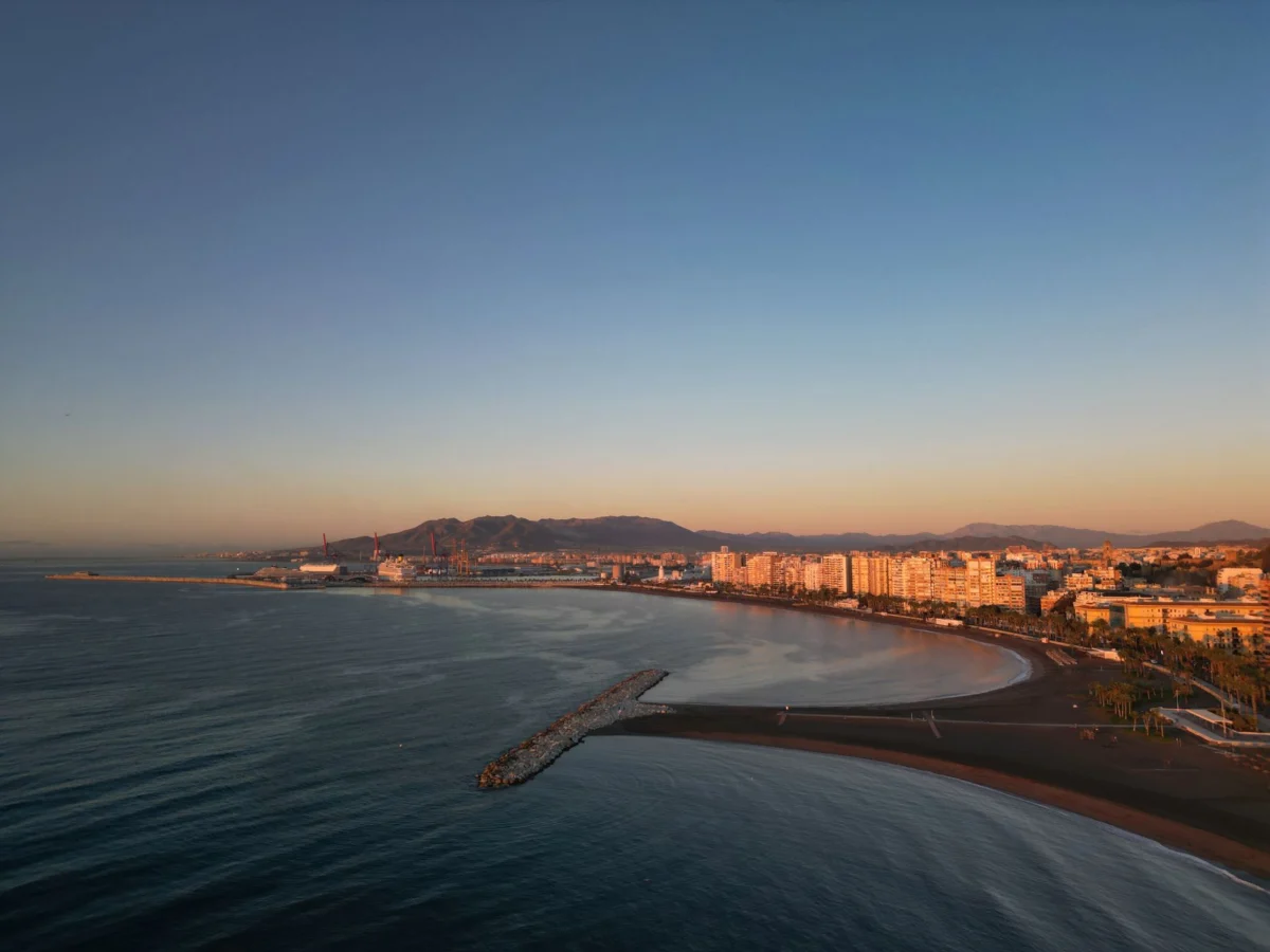Sunset over Malaga's serene coastline and cityscape