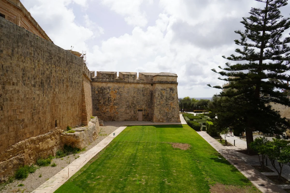 Picturesque view of Mdina's historic city walls at sunset