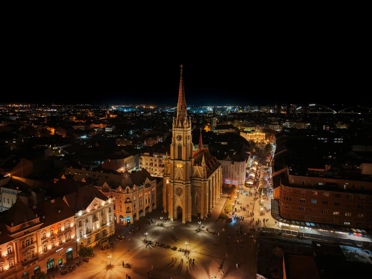 A romantic evening view of the Novi Sad skyline across the Danube River