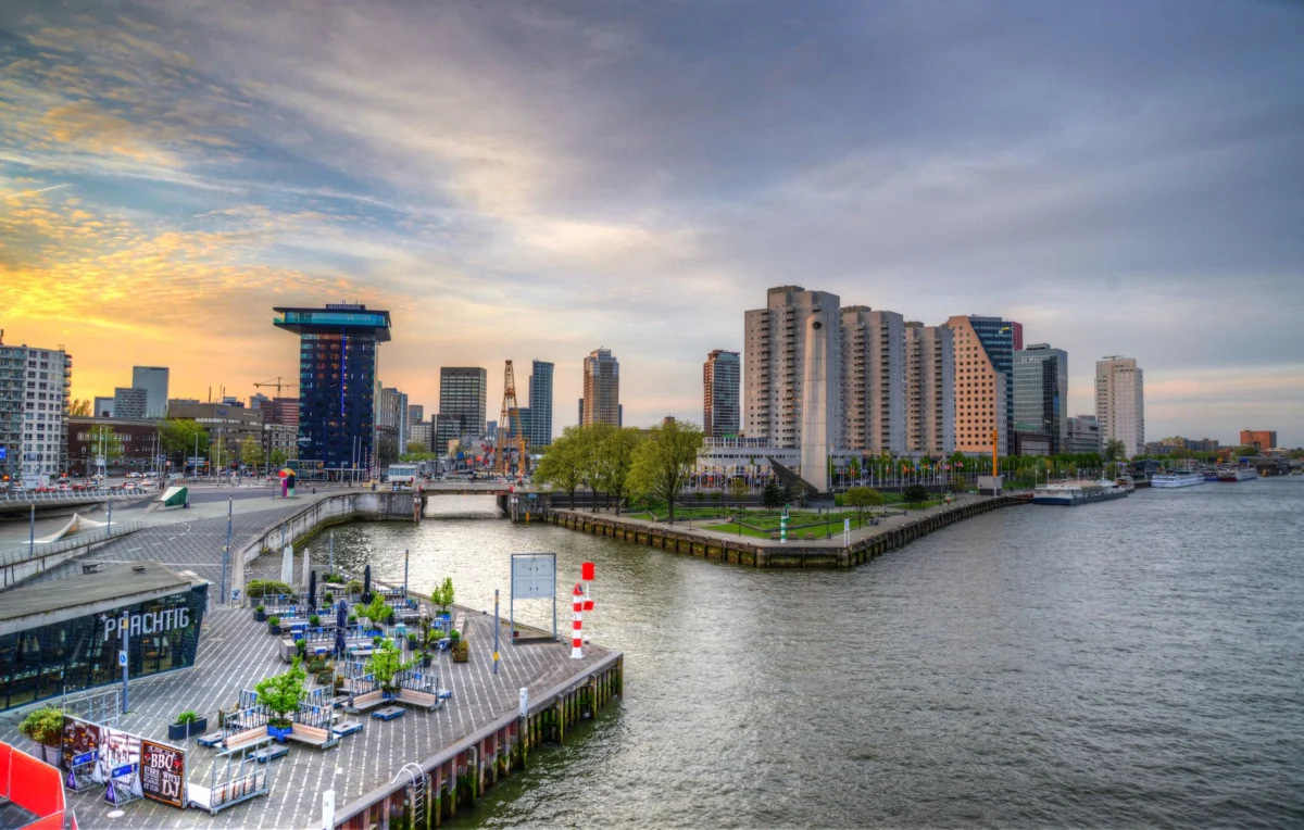 Romantic sunset view of Rotterdam skyline showcasing iconic landmarks