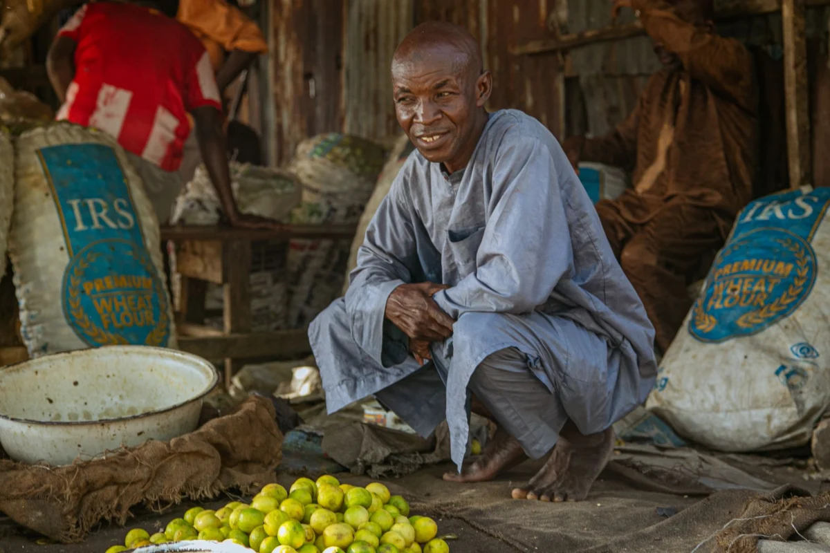 View of a bustling market in Senegambia with local food stalls