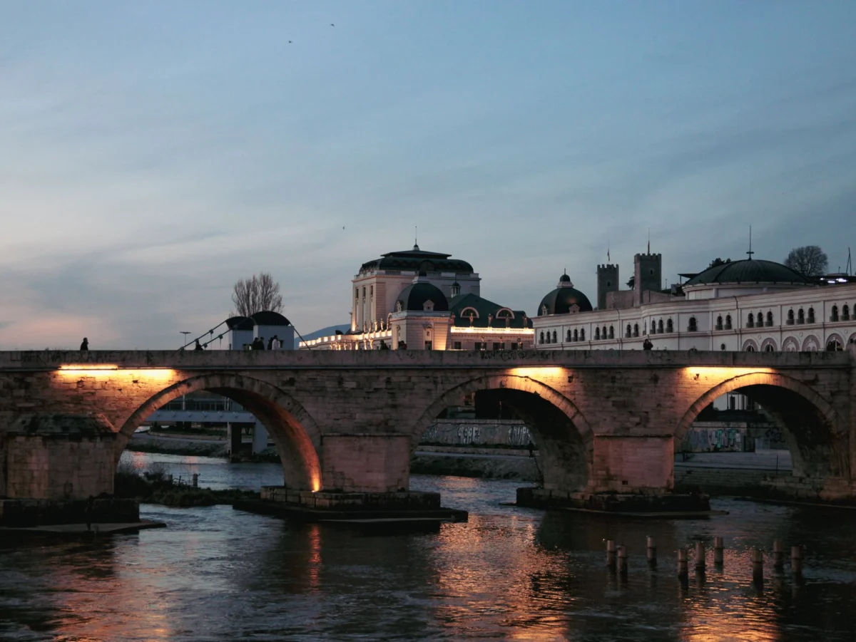 Skopje city skyline illuminated at night with cultural landmarks